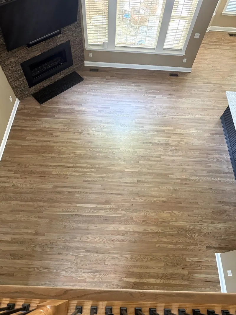 Family room with clean hardwood floors, seen from the stairs
